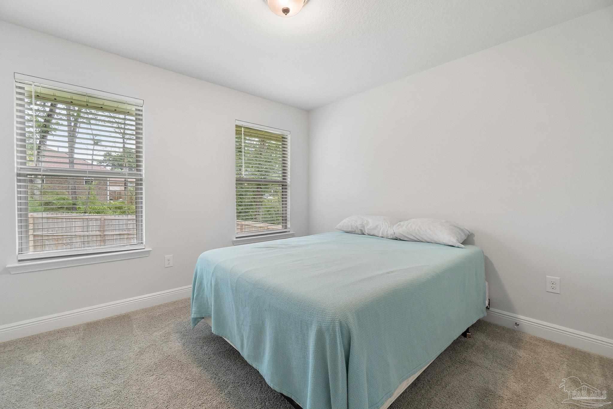 1463 Promenade Loop Cantonment, FL 32533 - Photo 28 of 41 a bed sitting in a bedroom next to a window