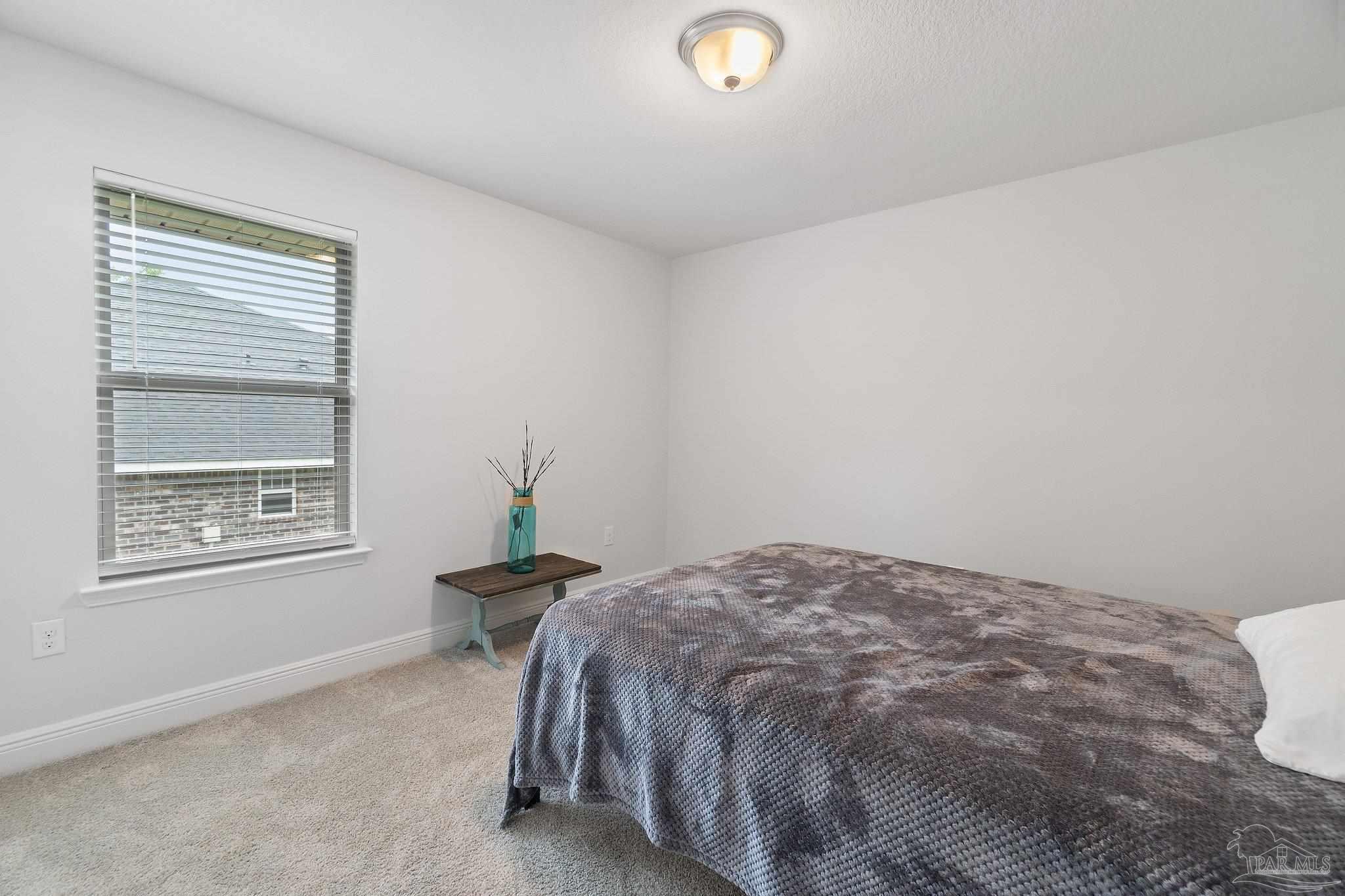 1463 Promenade Loop Cantonment, FL 32533 - Photo 30 of 41 a bedroom with a bed and wooden floor