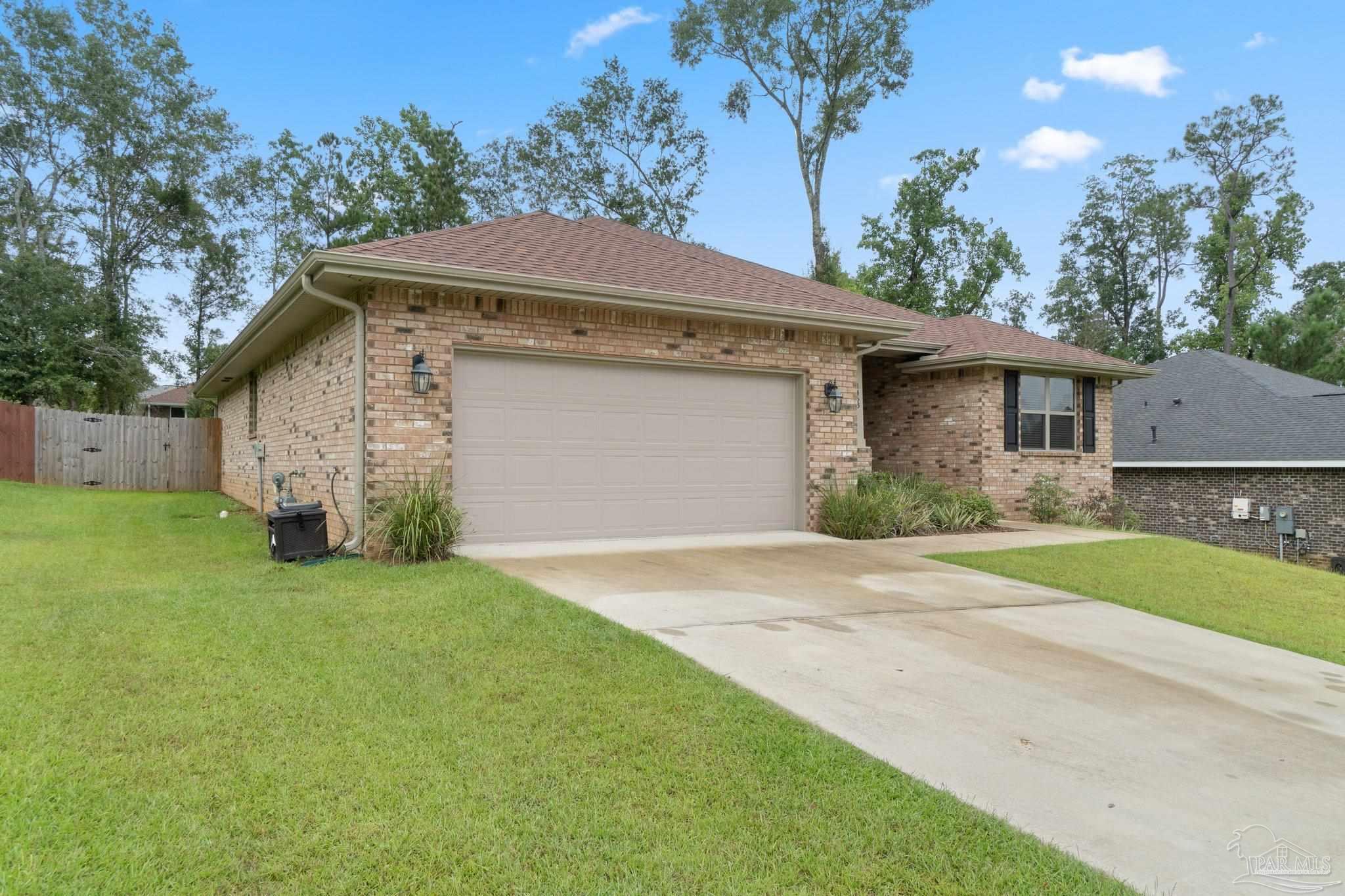 1463 Promenade Loop Cantonment, FL 32533 - Photo 3 of 41 a front view of a house with garden