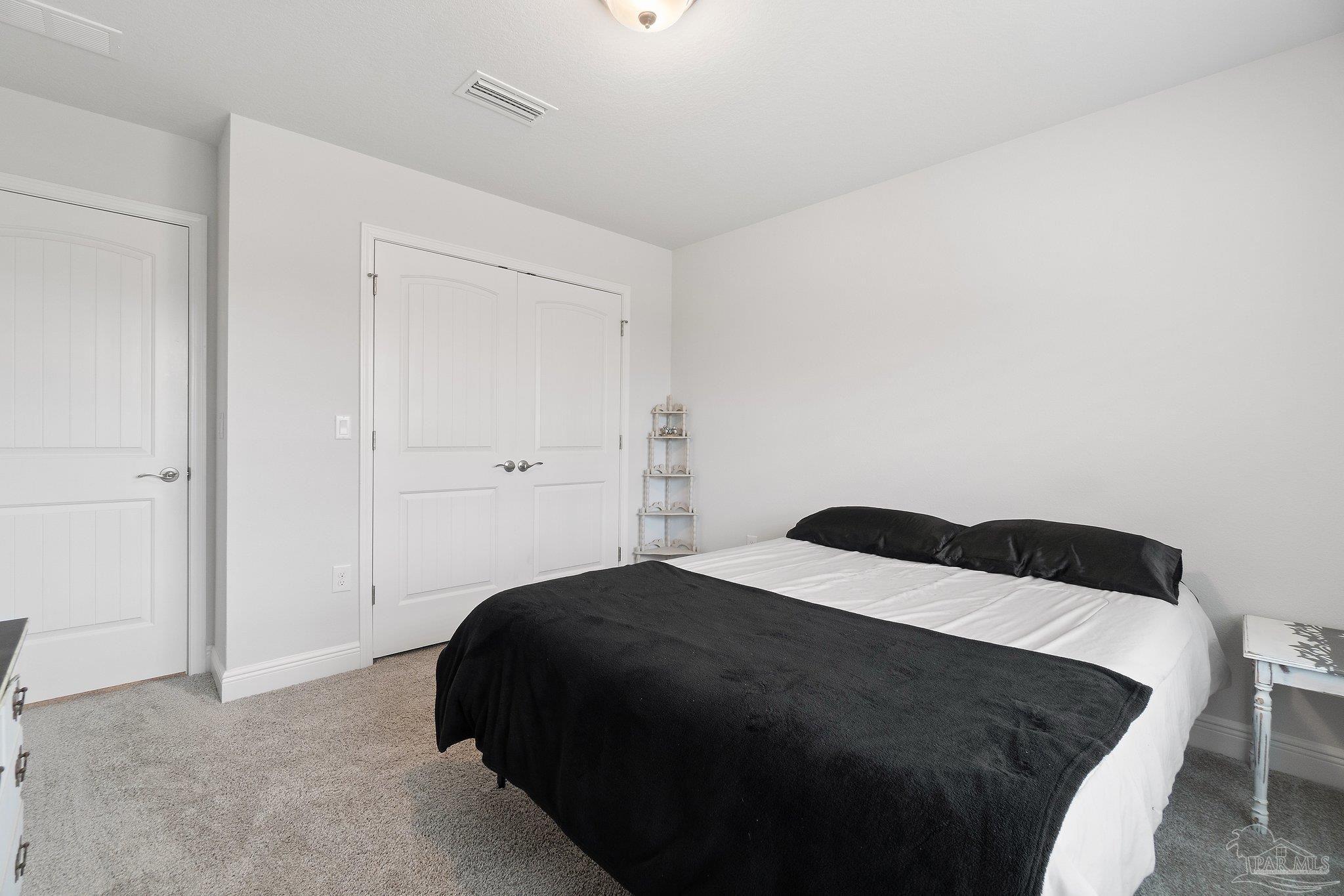 1463 Promenade Loop Cantonment, FL 32533 - Photo 34 of 41 a bedroom with a bed and a cabinets