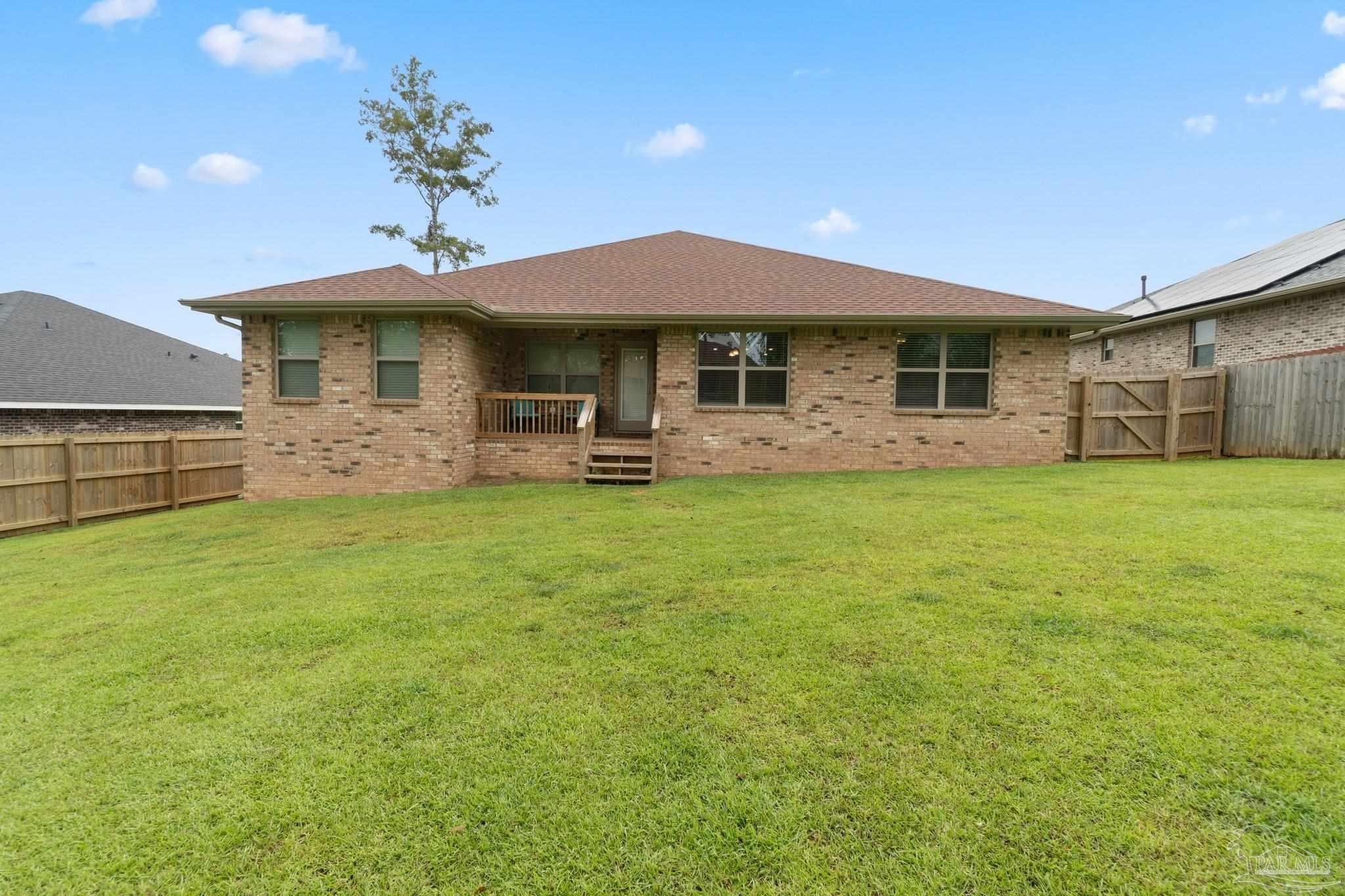 1463 Promenade Loop Cantonment, FL 32533 - Photo 38 of 41 a front view of a house with garden