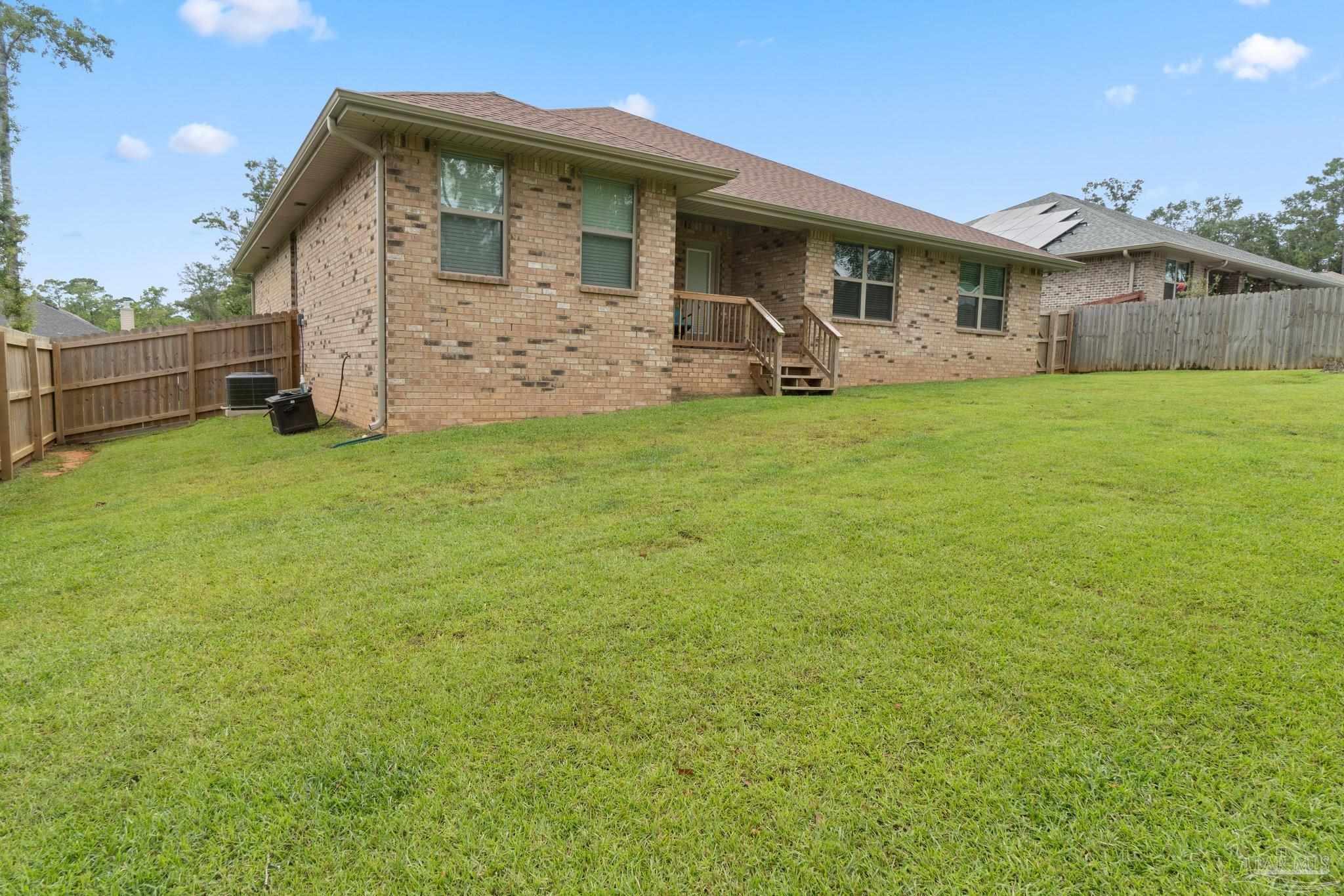 1463 Promenade Loop Cantonment, FL 32533 - Photo 39 of 41 a front view of a house with garden
