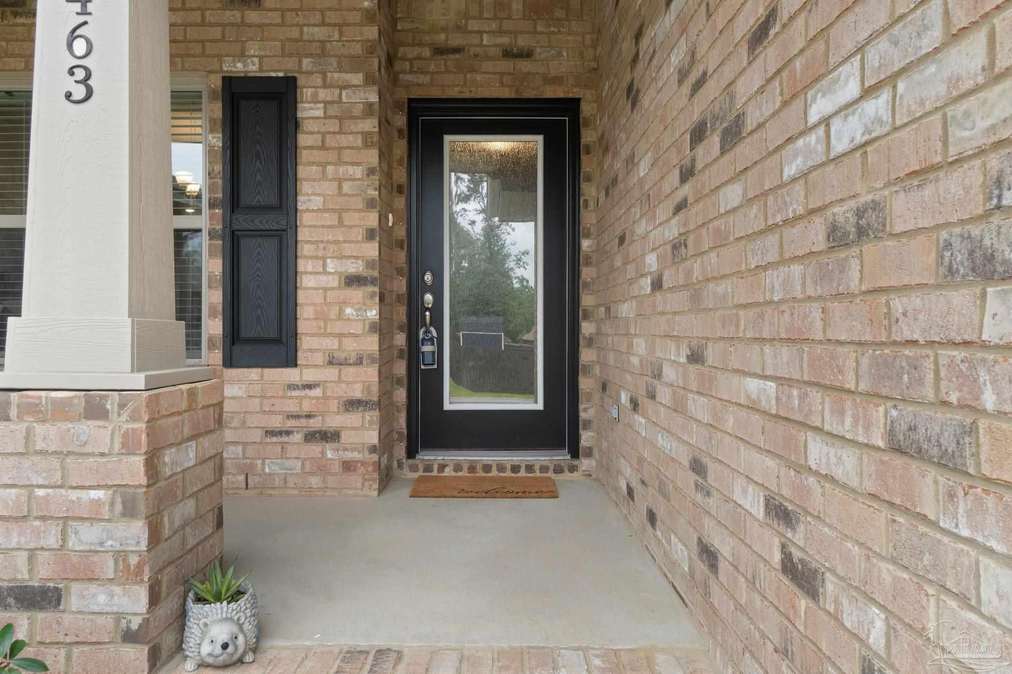 1463 Promenade Loop Cantonment, FL 32533 - Photo 5 of 41 a front view of a house with a brick wall
