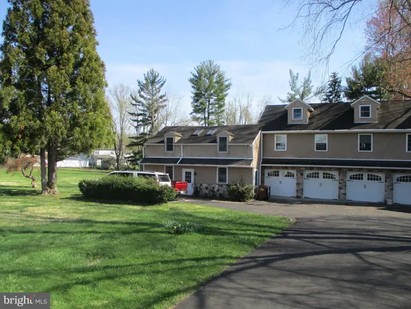a view of a house with a big yard and potted plants