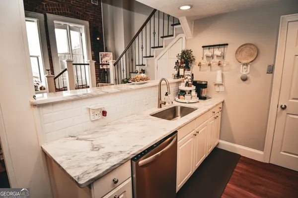 a kitchen with a sink a stove and cabinets