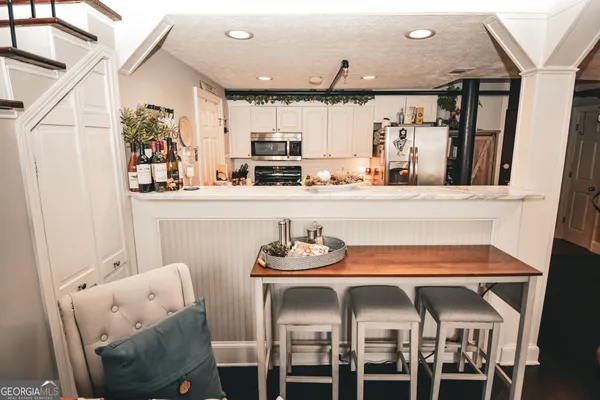 a dining room with furniture and window