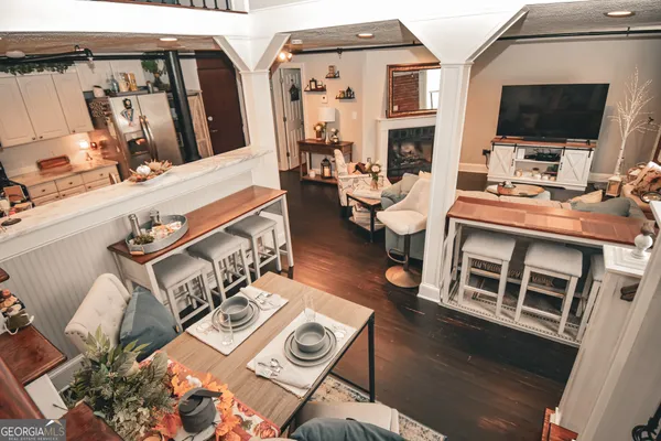 a living room with patio furniture and a flat screen tv