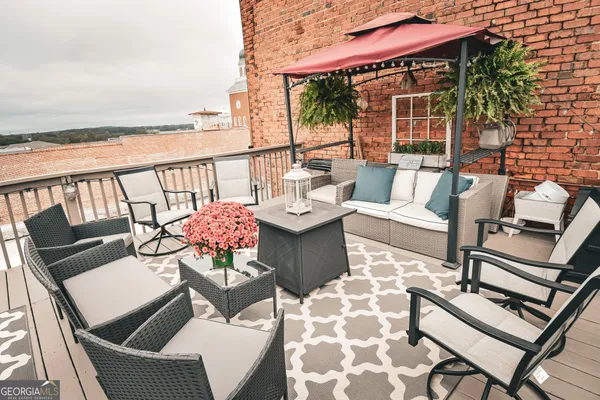 a view of a dining tables and chairs in the balcony