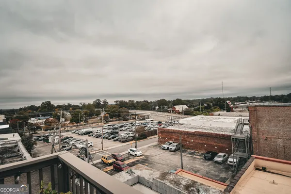 a balcony with table and chairs