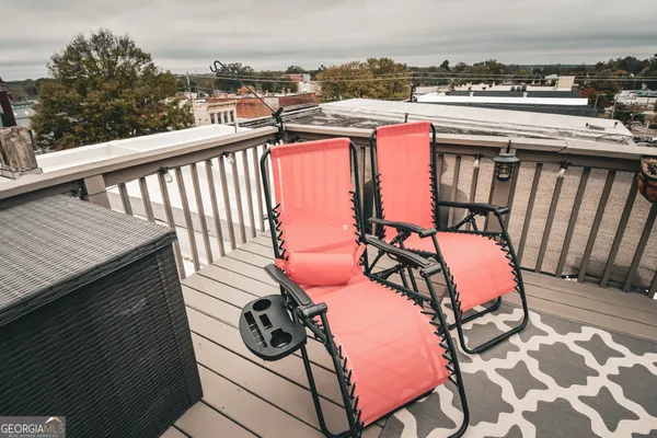 a view of a balcony with wooden benches