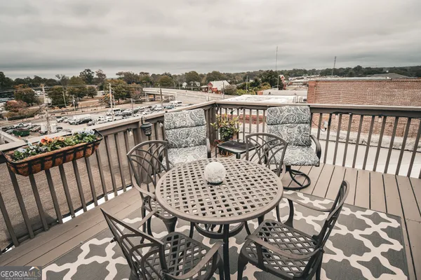 a view of a balcony with a chairs
