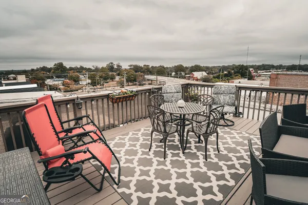 a view of a roof deck with furniture