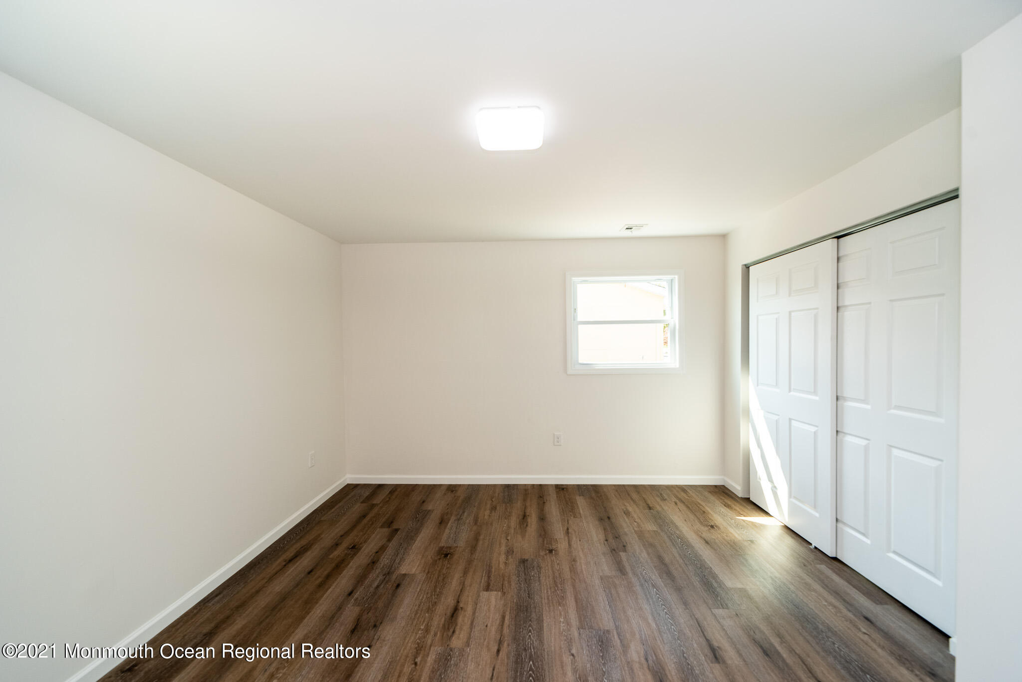 222 Edison Road Barnegat, NJ 08005 - Photo 22 of 50 an empty room with wooden floor and windows