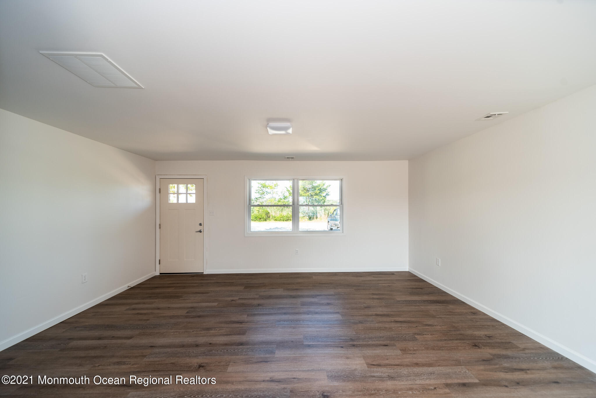 222 Edison Road Barnegat, NJ 08005 - Photo 5 of 50 an empty room with wooden floor and windows