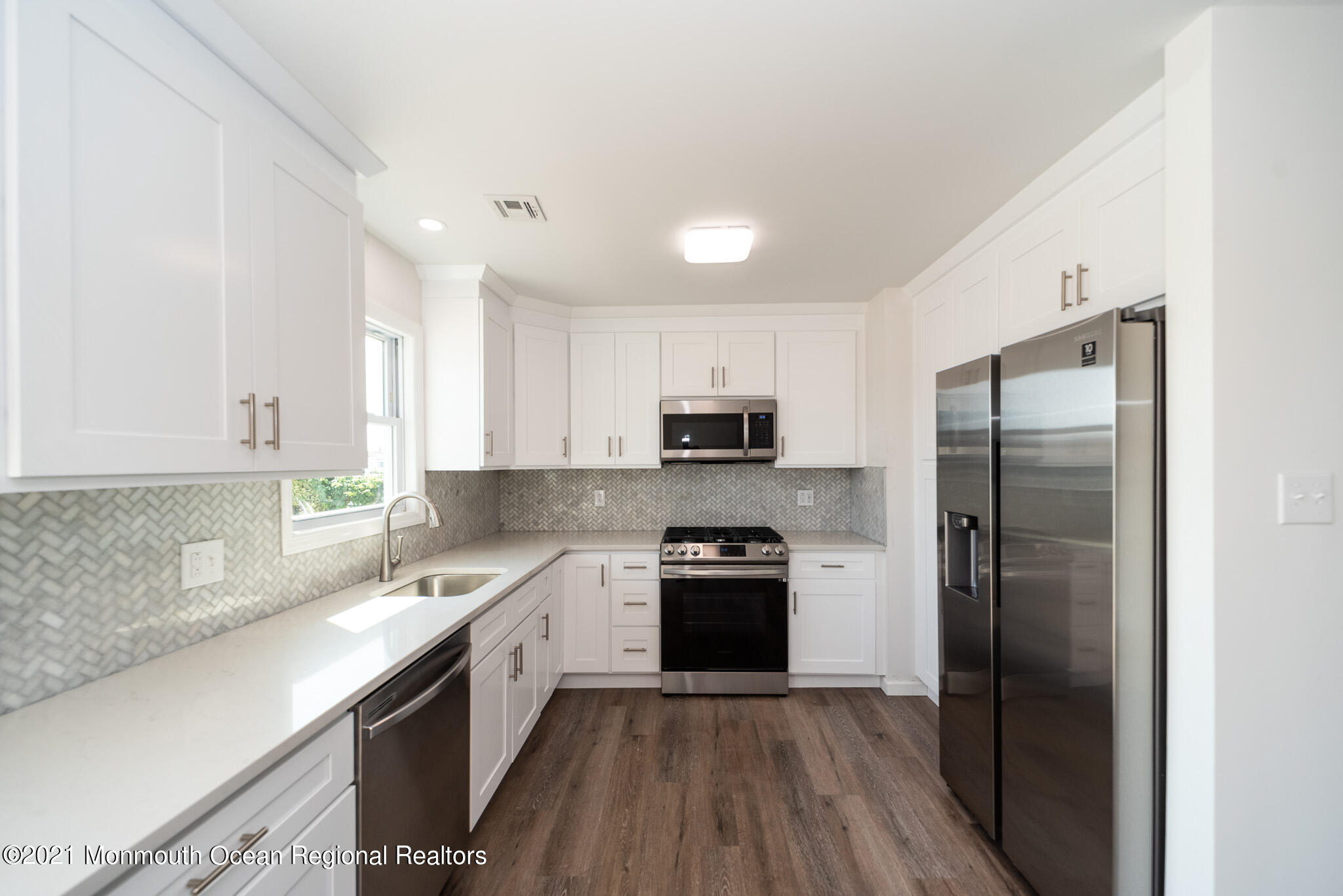 222 Edison Road Barnegat, NJ 08005 - Photo 8 of 50 a kitchen with a refrigerator sink and wooden floor