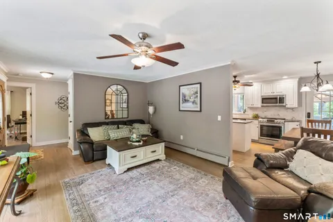 a living room with furniture and kitchen view