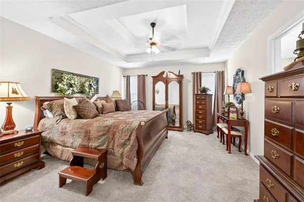 a spacious bedroom with a bed and a walk in closet