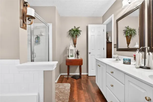 a spacious bathroom with a double vanity sink and a window