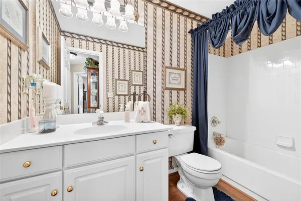 a bathroom with a sink a toilet and a bathtub