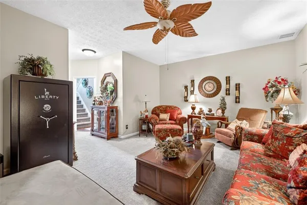 a living room with furniture and a clock
