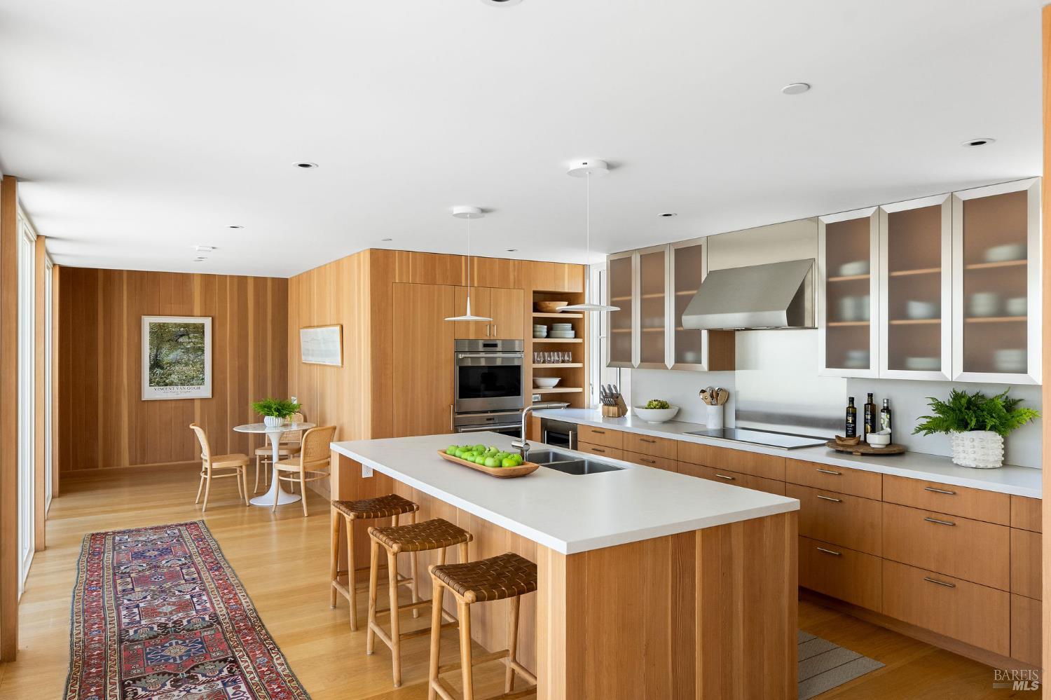 18907 Highway 128 Calistoga, CA 94515 - Photo 14 of 46 a kitchen with stainless steel appliances granite countertop a dining table and chairs with wooden floor