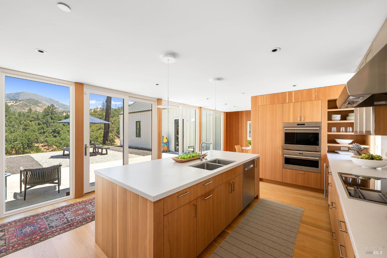 18907 Highway 128 Calistoga, CA 94515 - Photo 16 of 46 a kitchen with stainless steel appliances granite countertop a stove top oven a sink and a refrigerator