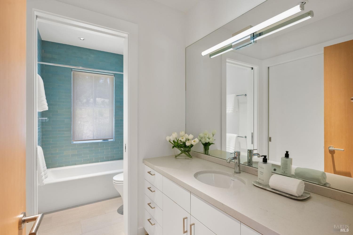 18907 Highway 128 Calistoga, CA 94515 - Photo 21 of 46 a bathroom with a granite countertop tub sink and mirror