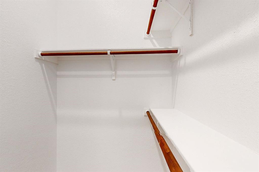 4907 Escape Rivera Drive Austin, TX 78747 - Photo 11 of 28 Ample storage solutions with versatile shelving and hanging rods in this well-appointed closet.