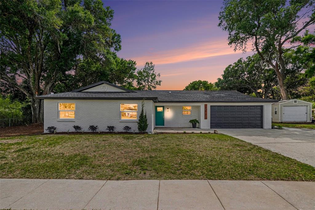 a house that has a large tree in front of it