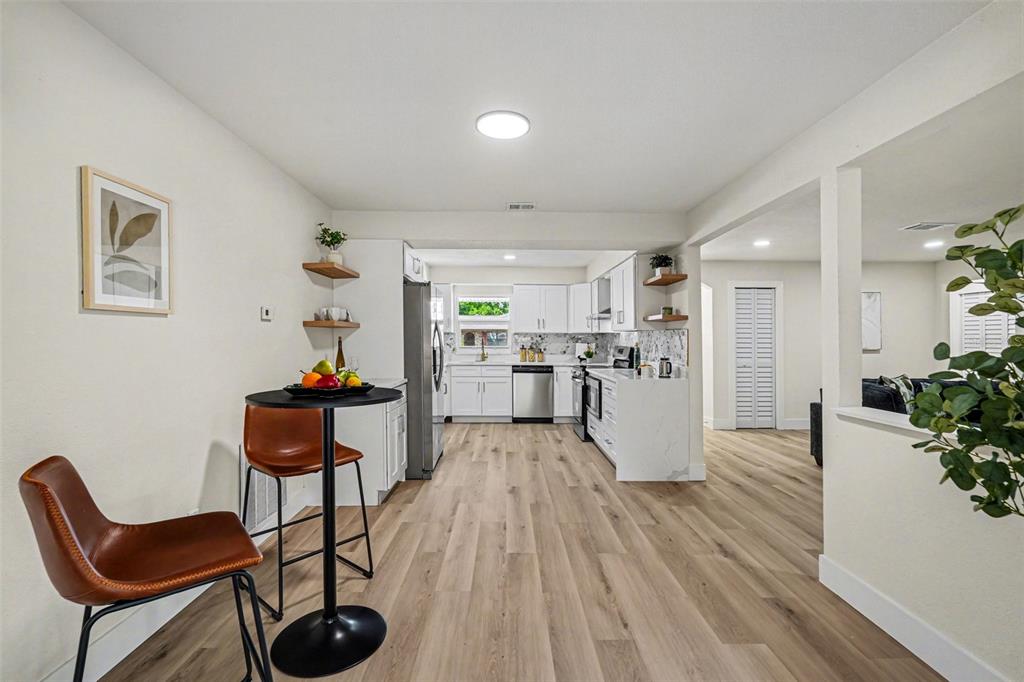 707 Queens Court Seffner, FL 33584 - Photo 12 of 28 a dining room with furniture and wooden floor