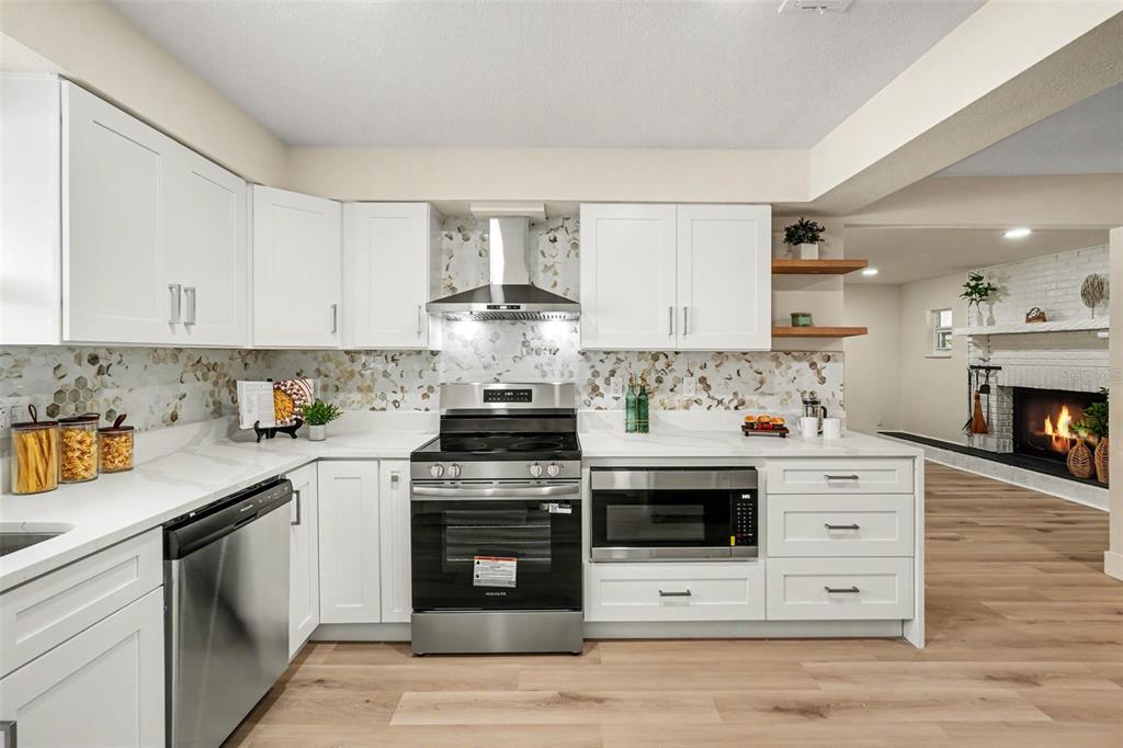 707 Queens Court Seffner, FL 33584 - Photo 16 of 28 a kitchen with stainless steel appliances a stove a sink and a microwave