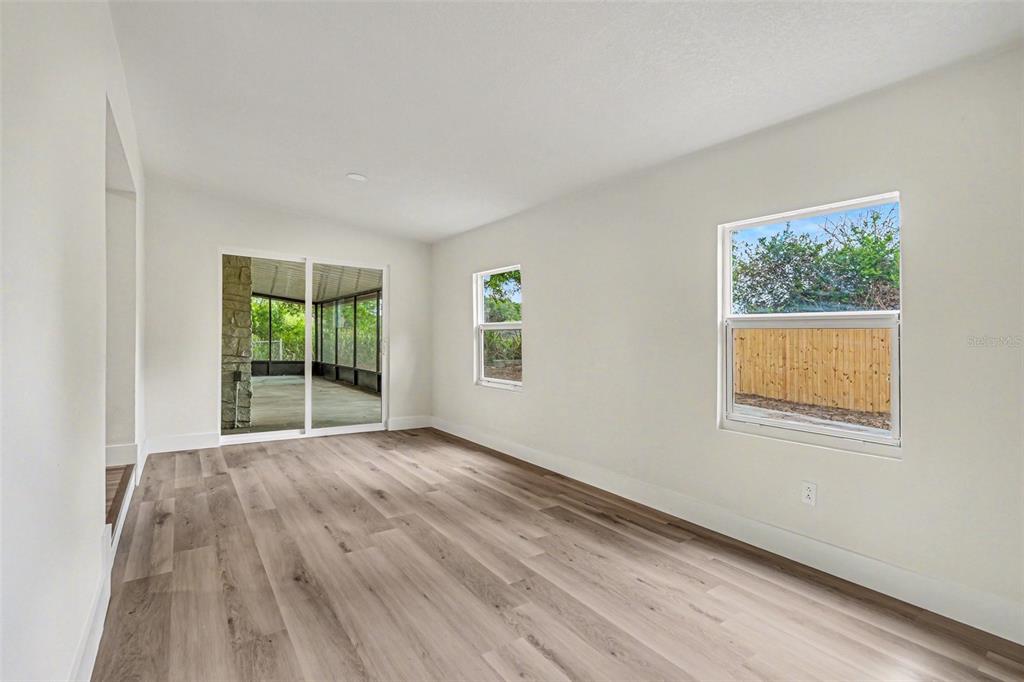 707 Queens Court Seffner, FL 33584 - Photo 20 of 28 a view of an empty room with wooden floor and a window