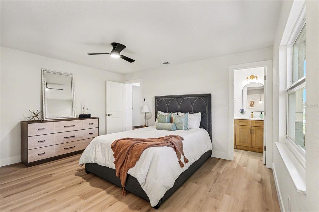 707 Queens Court Seffner, FL 33584 - Photo 22 of 28 a bedroom with a bed and a dresser