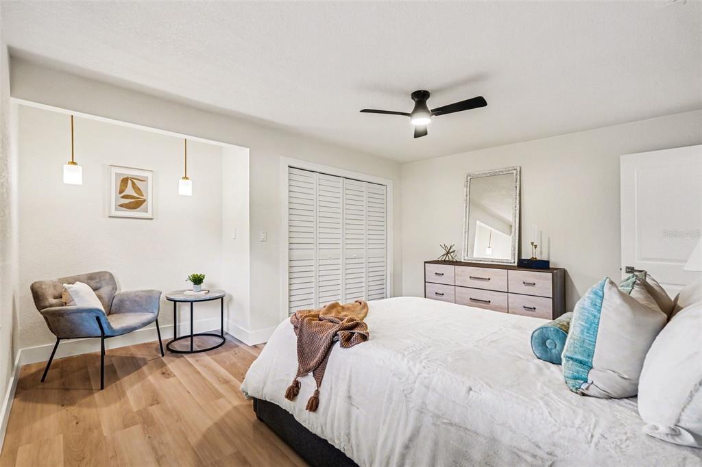 707 Queens Court Seffner, FL 33584 - Photo 23 of 28 a bedroom with bed and a chair