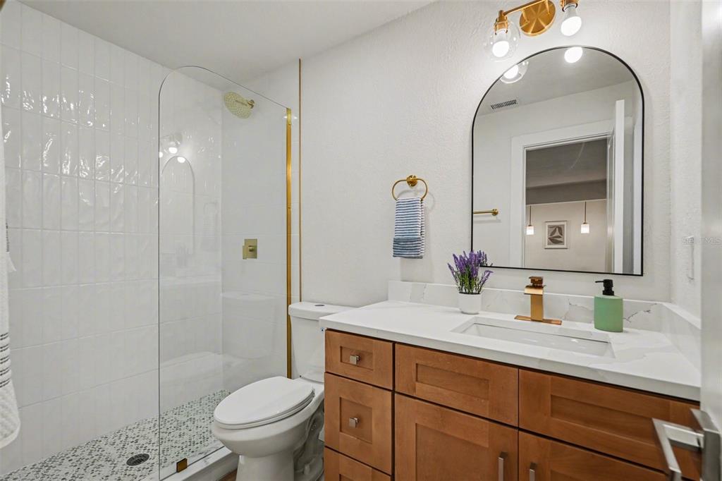 707 Queens Court Seffner, FL 33584 - Photo 25 of 28 a bathroom with a sink a toilet and shower