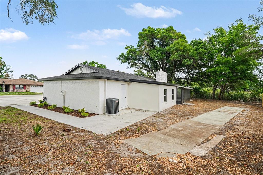 707 Queens Court Seffner, FL 33584 - Photo 28 of 28 a white house that has a tree in front of it