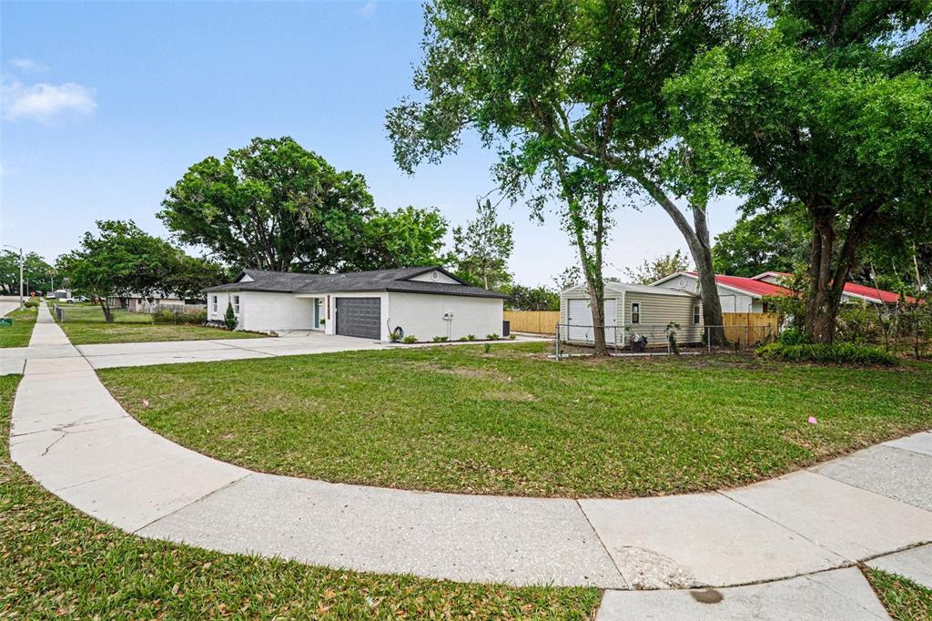 707 Queens Court Seffner, FL 33584 - Photo 5 of 28 a view of a house with a backyard