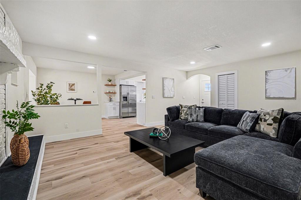 707 Queens Court Seffner, FL 33584 - Photo 6 of 28 a living room with furniture potted plant and kitchen view