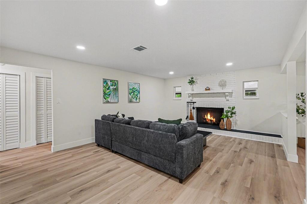 707 Queens Court Seffner, FL 33584 - Photo 7 of 28 a living room with furniture and a fireplace