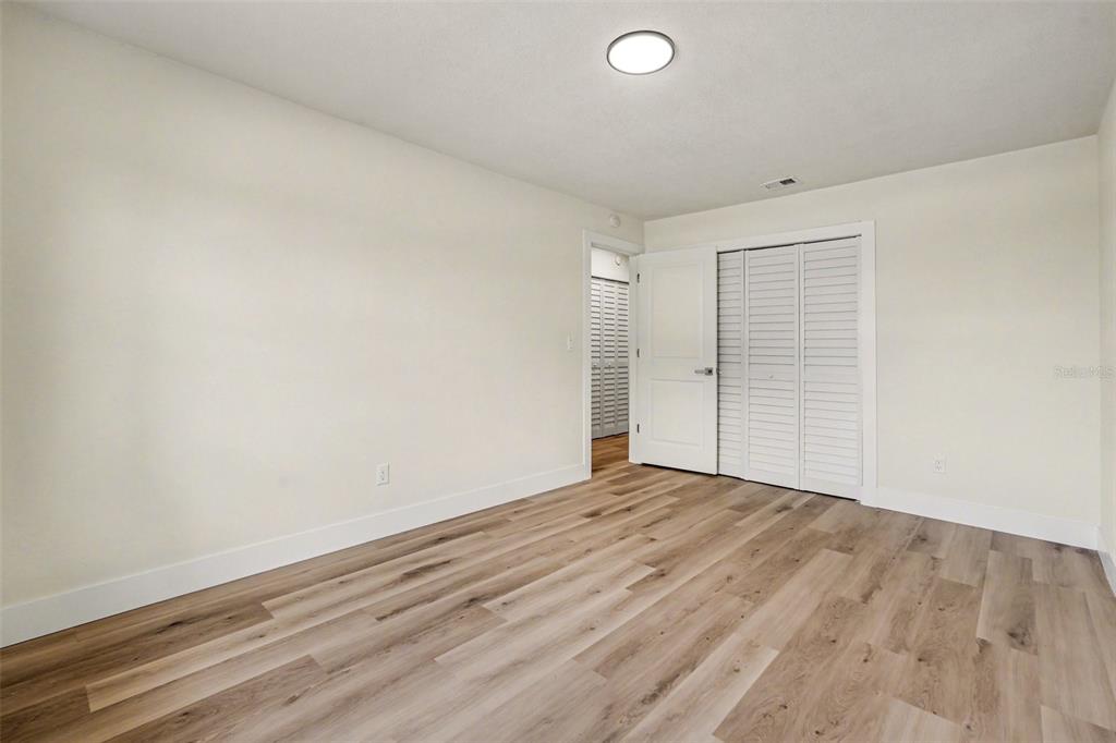 707 Queens Court Seffner, FL 33584 - Photo 9 of 28 a view of empty room with wooden floor