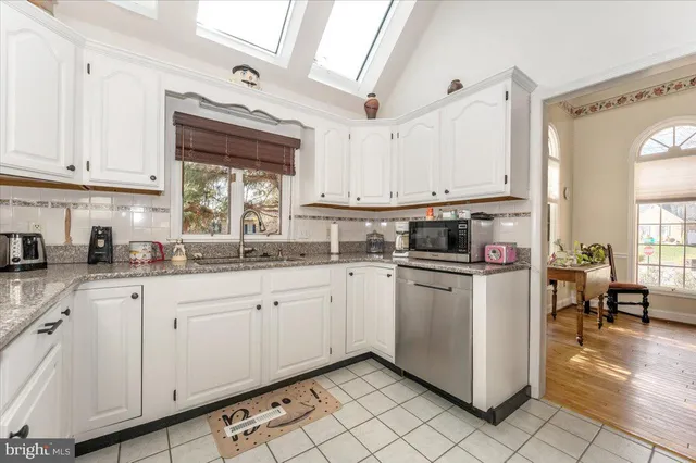 a view of a dining room with furniture and a chandelier
