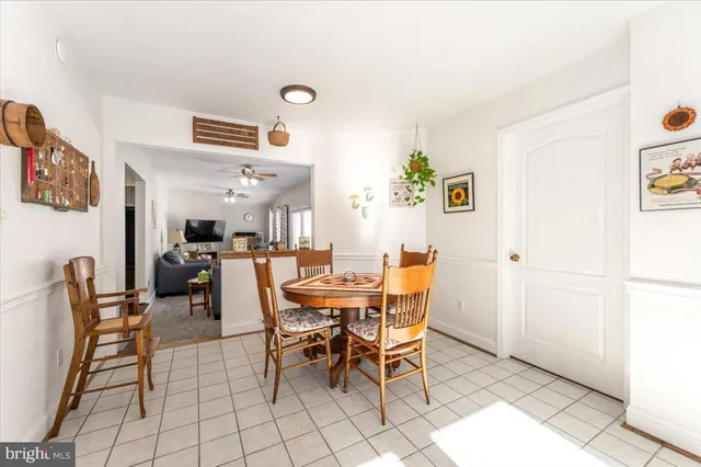 a living room with furniture a rug and white walls
