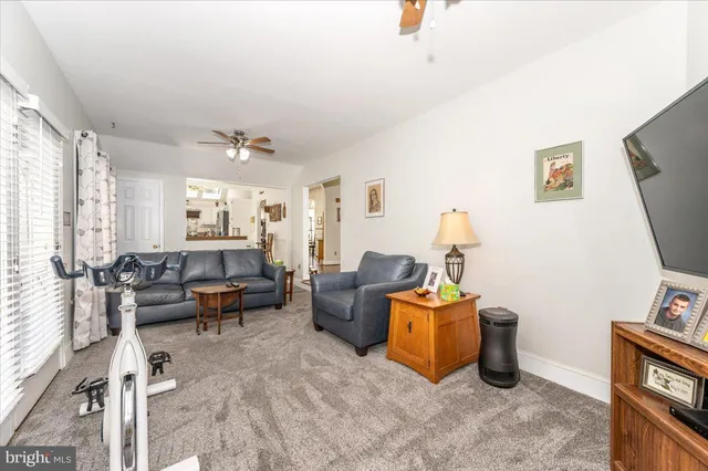 a view of a hallway with wooden floor and furniture