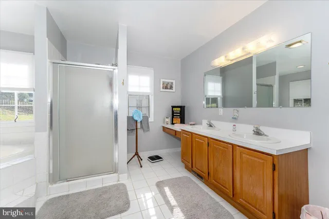 a spacious bathroom with double sink and a mirror