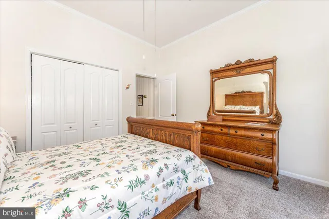 a dining room with furniture a rug a chandelier and wooden floor