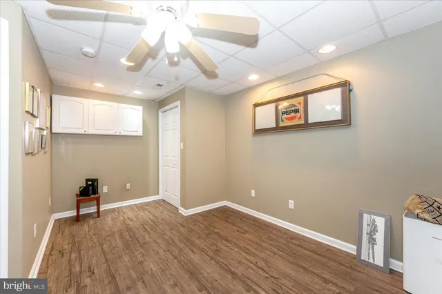 a view of a house with a big yard and large trees
