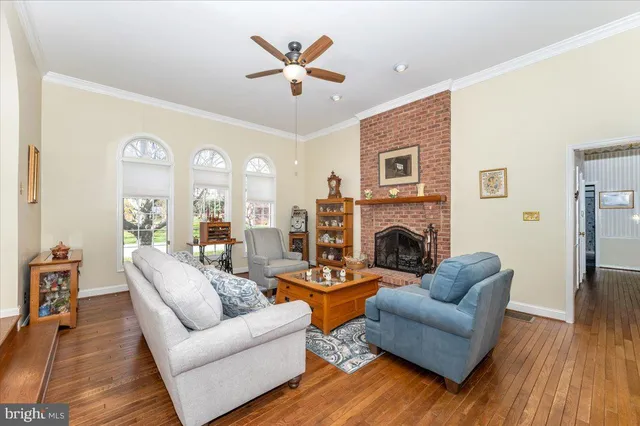 a living room with furniture fireplace and a table