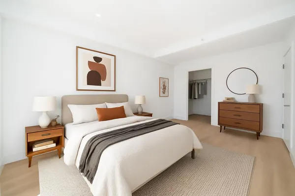 a bedroom with bed and a chandelier