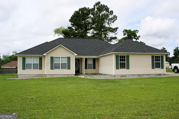 a front view of a house with a yard