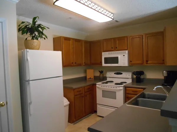 a white refrigerator freezer sitting inside of a kitchen